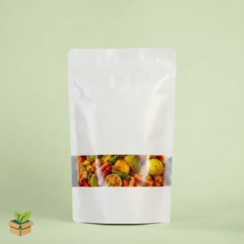 White stand‑up pouch with transparent window showing mixed pickles on light green background.